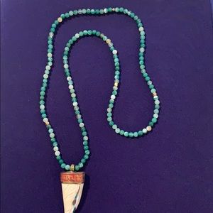 Green beaded necklace with horn detail